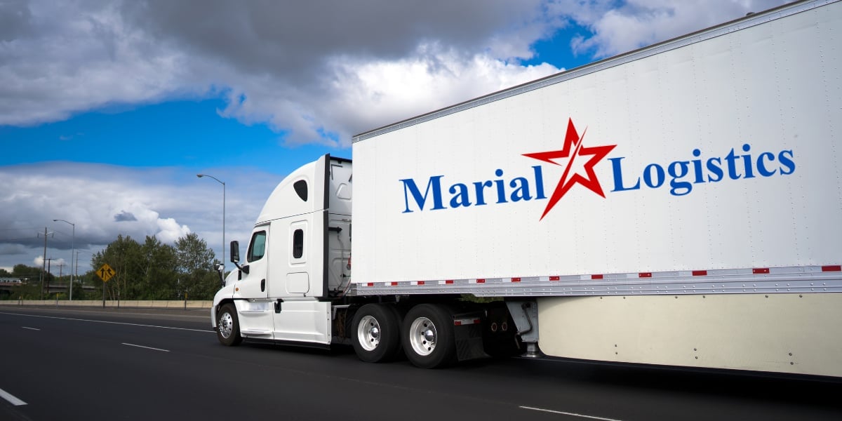 White semi-truck with Maria Logistics red star logo on the trailer, driving on a highway under cloudy skies